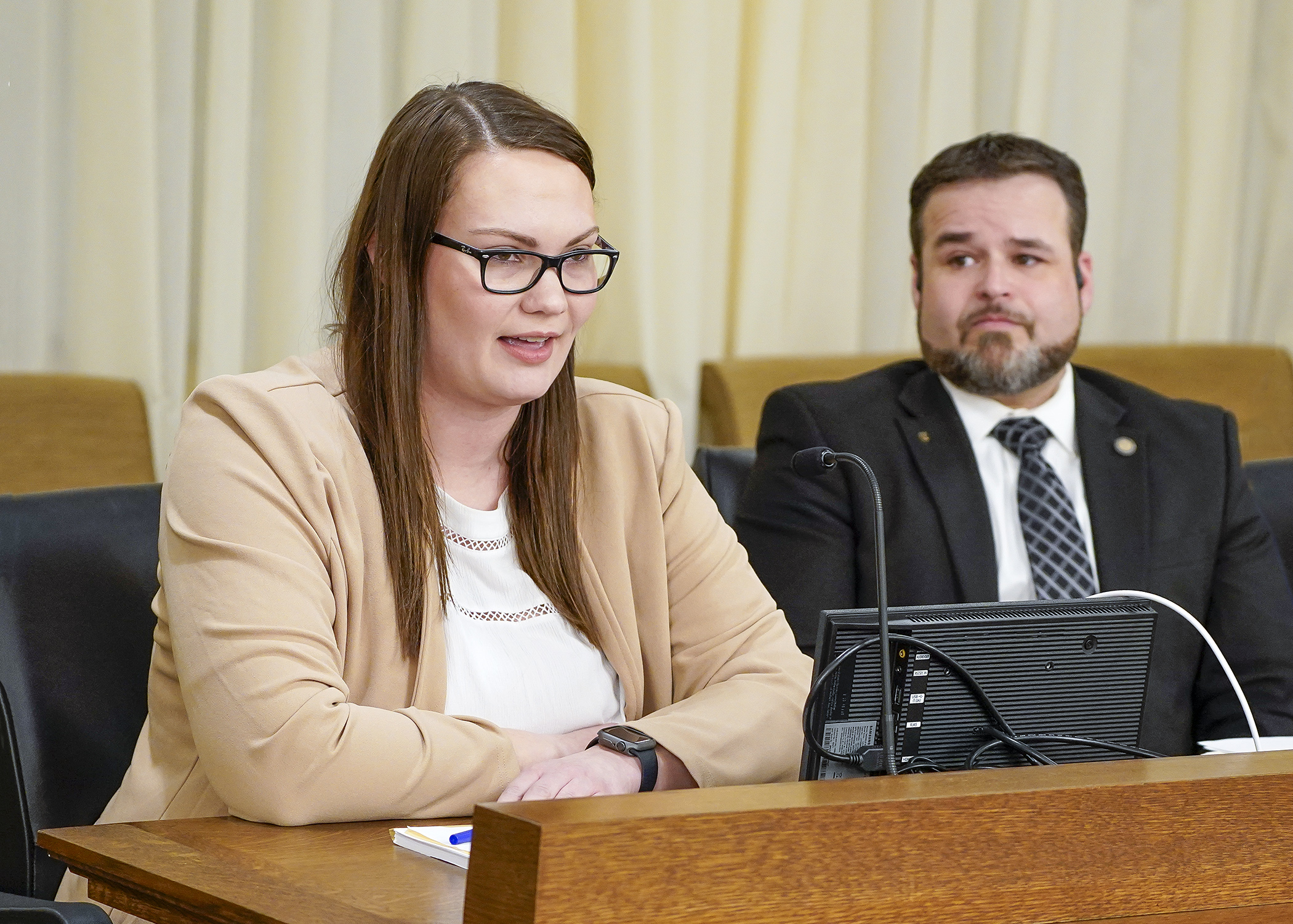 Lauren Servick testifies on behalf of the Minnesota Pork Producers Association Jan. 23 before the House environment committee in support of a bill sponsored by Rep. Josh Heintzman, right. (Photo by Andrew VonBank)